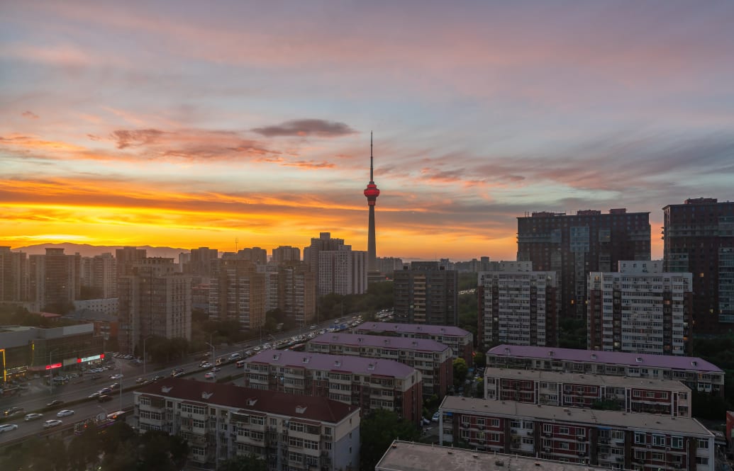 A photo of the Beijing skyline at sunset.
