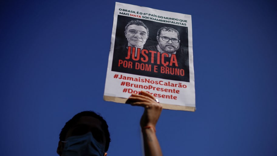 A demonstrator holds a sign during a protest to demand justice for journalist Dom Phillips and indigenous expert Bruno Pereira, who were murdered in the Amazon, in Brasilia, Brazil, June 19, 2022. 