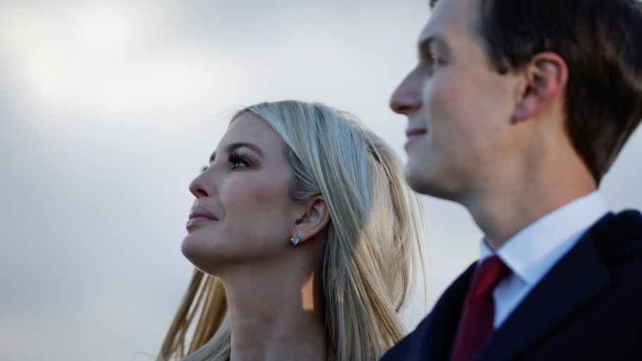Ivanka Trump and Jared Kushner watch on during an outdoor speech