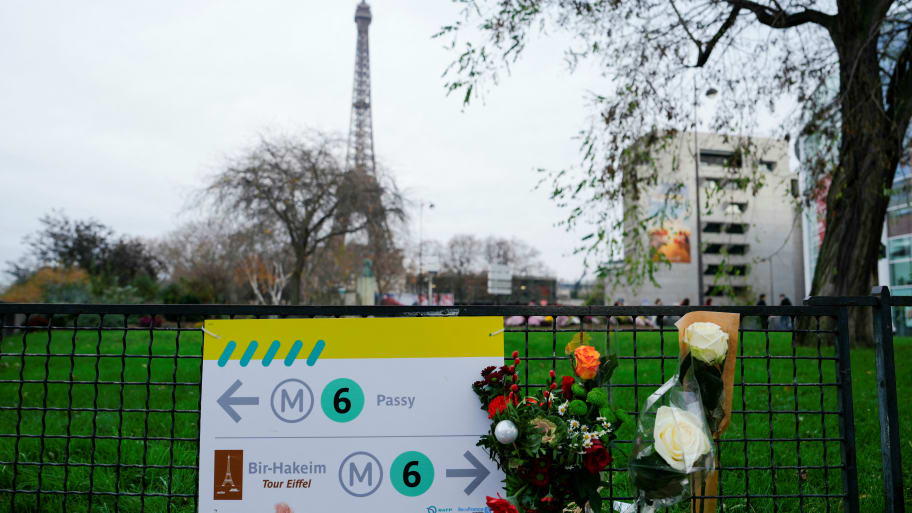 Flowers where a tourist was stabbed to death near the Eiffel Tower 