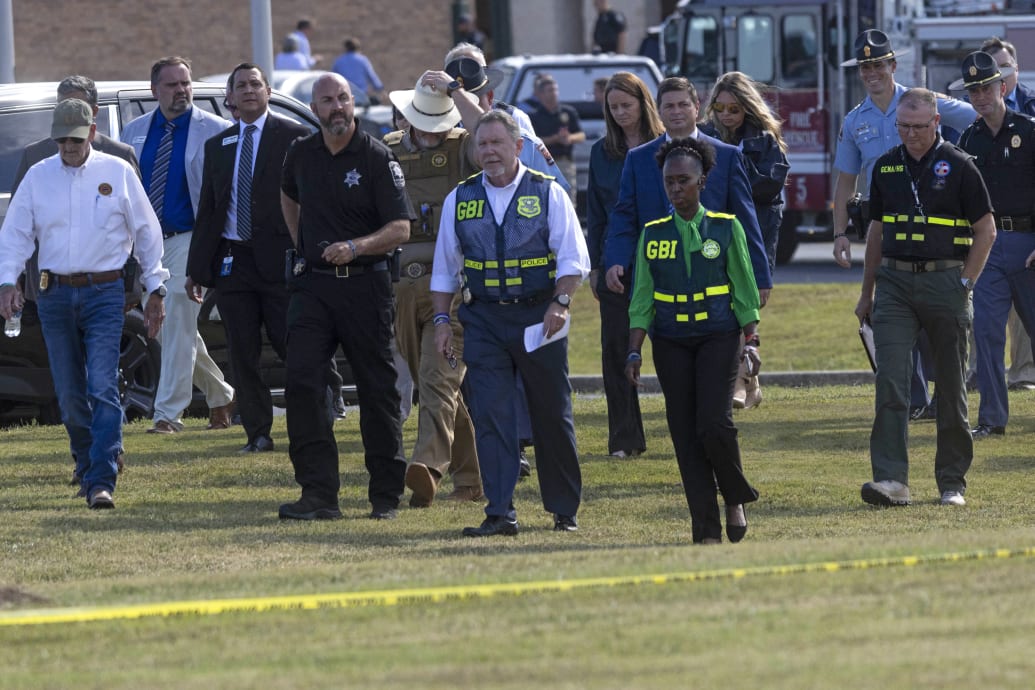 Law enforcement officials arrive to give a press conference outside of Apalachee High School in Winder, Georgia, on September 4, 2024, after a shooting took place