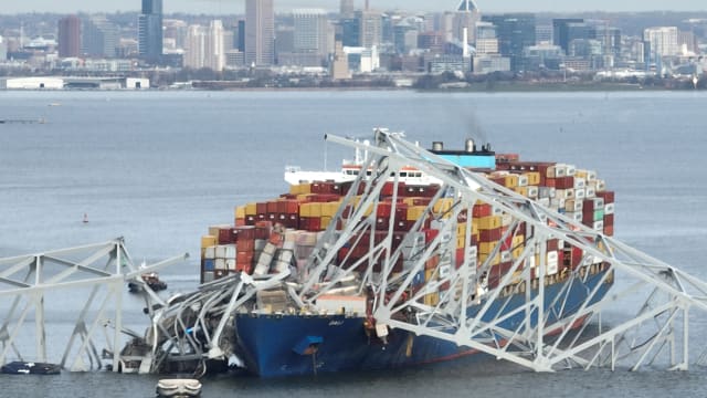 The frame of the Francis Scott Key bridge in Baltimore sits on top of the cargo ship Dali after the collapse.