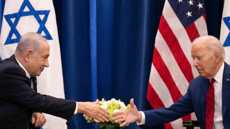 Israeli Prime Minster Benjamin Netanyahu and U.S. President Joe Biden move to shake hands. 