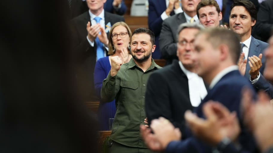 Ukrainian President Volodymyr Zelensky (C) with Canadian Prime Minister Justin Trudeau (R), acknowdledges a Canadian-Ukrainian war veteran after addressing the House of Commons in Ottawa, Canada, on September 22.