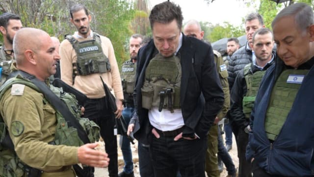 Elon Musk (C) and Israeli delegation, including Benjamin Netanyahu (R), visit the Kfar Aza settlements in southern Israel, one of the locations targeted by Hamas on Oct. 7, in Kfar Aza, Israel, on Nov. 27, 2023.