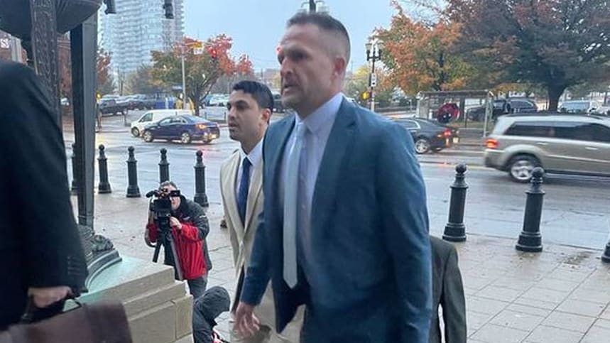 Brett Hankison (right), 47, arrives in court on Monday alongside his attorneys for the beginning of his federal trial