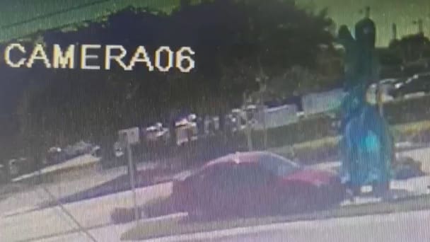 A screenshot of surveillance footage showing Derek Alan Modrok crashing his car into the sculpture.