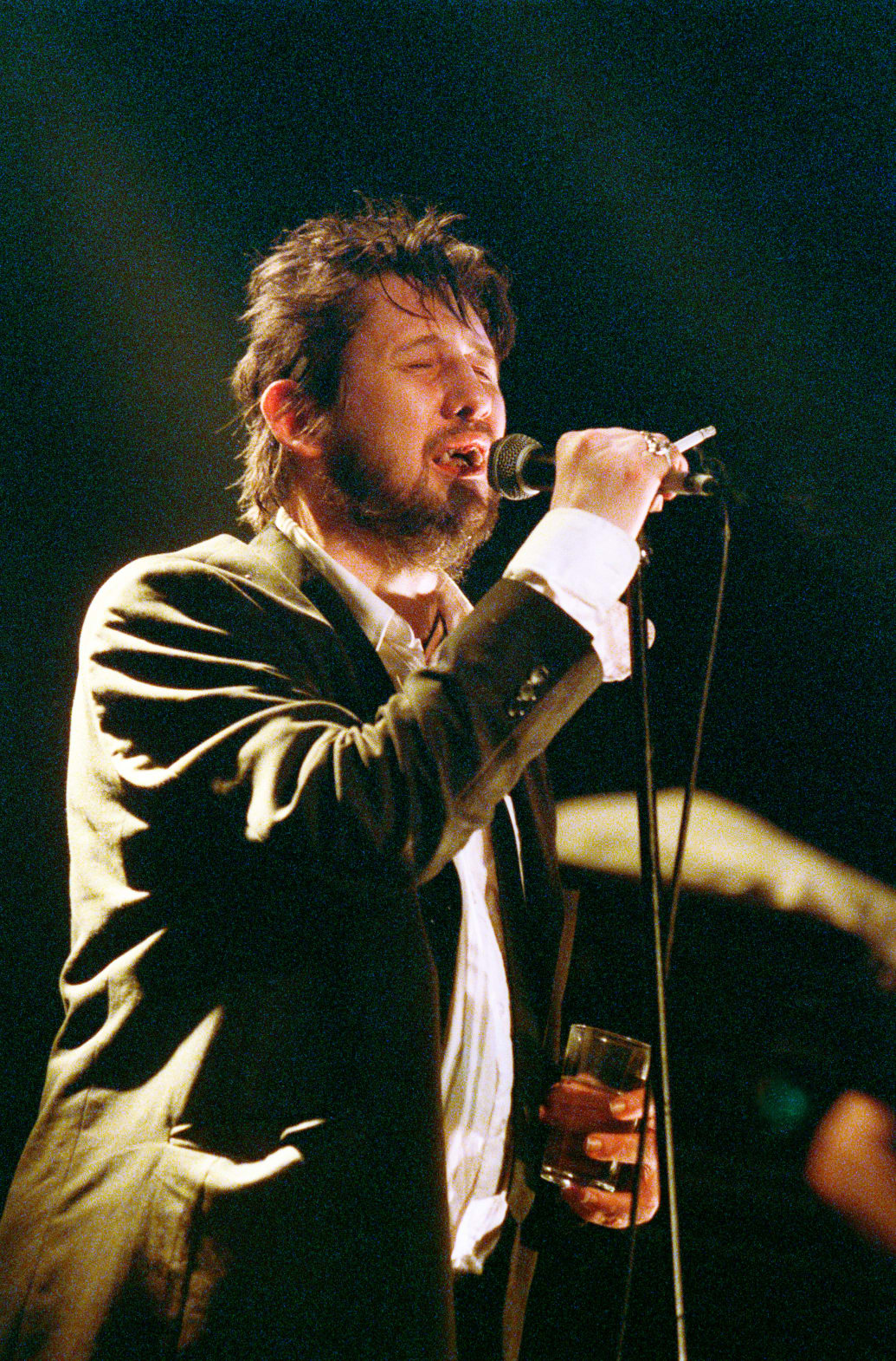 A photograph of Shane MacGowan performing on April 18th 2002 at the Melkweg in Amsterdam, Netherlands. 
