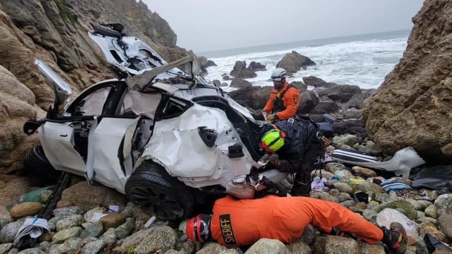 Emergency responders at the scene of a crashed white Tesla in the Devil’s Slide area of Northern California. 