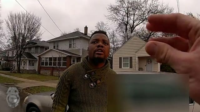 A Grand Rapids Police officer asks Patrick Lyoya if he speaks English