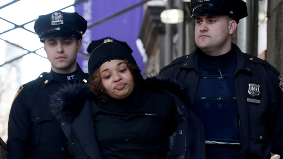 NYPD officers take suspect Shanice Aviles to Central Booking.