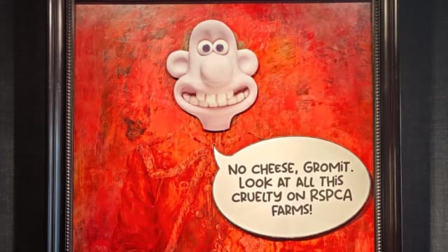 Animal rights activists briefly defaced King Charles III’s official portrait with a “Wallace and Gromit” sticker in a London gallery.