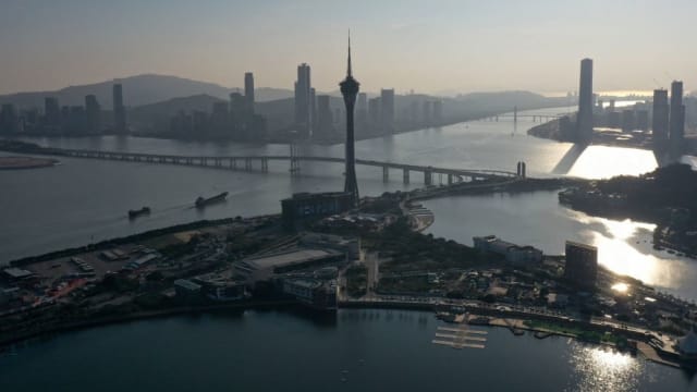This photo taken on January 18, 2023 shows an aerial view of the Macau Tower (C) in the southern Chinese enclave of Macau. 