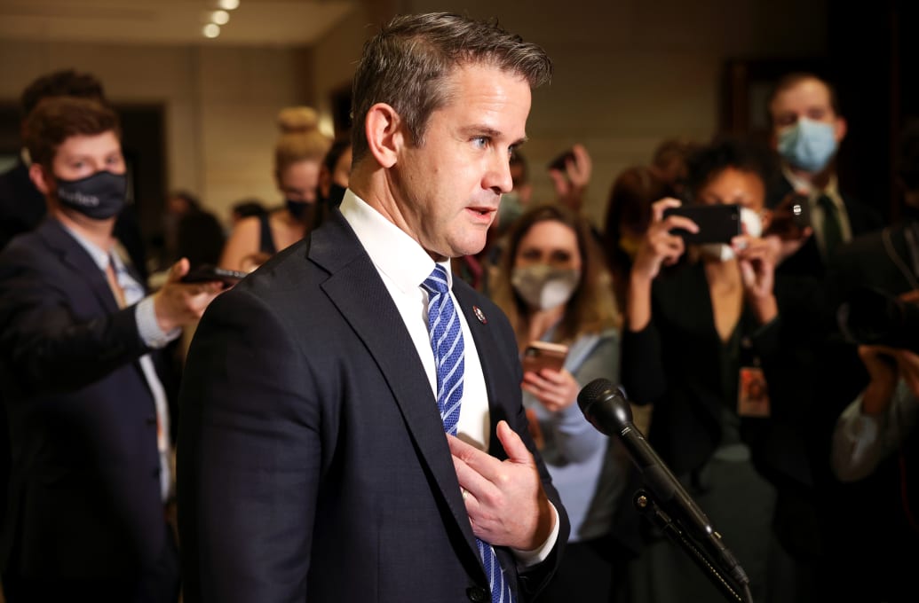 Adam Kinzinger speaks to reporters.