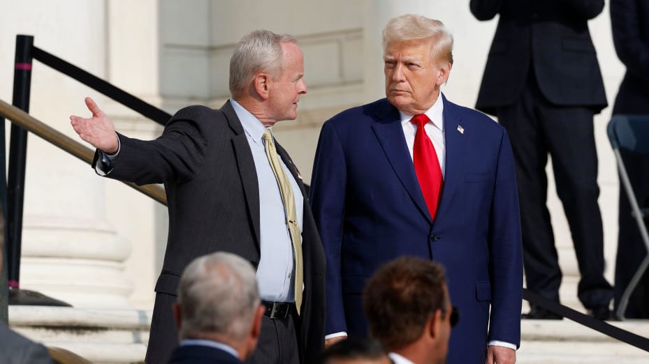 Former U.S. President Donald Trump (R) observes a changing of the guard at the Tomb of the Unknown Soldier at Arlington National Cemetery.