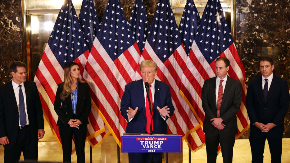 Donald Trump speaks in a news conference in front of his legal team.