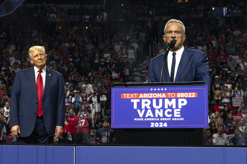 Former presidential candidate Robert F. Kennedy Jr. (R) speaks as Republican presidential nominee, former U.S. President Donald Trump listens during a campaign rally at Desert Diamond Arena on August 23, 2024 in Glendale, Arizona.  