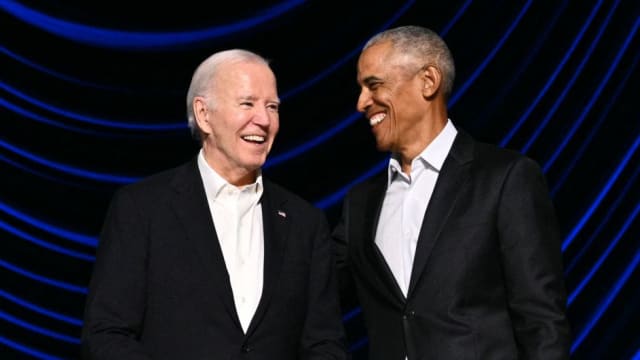 U.S. President Joe Biden (L) laughs with former President Barack Obama onstage during a campaign fundraiser at the Peacock Theater in Los Angeles.