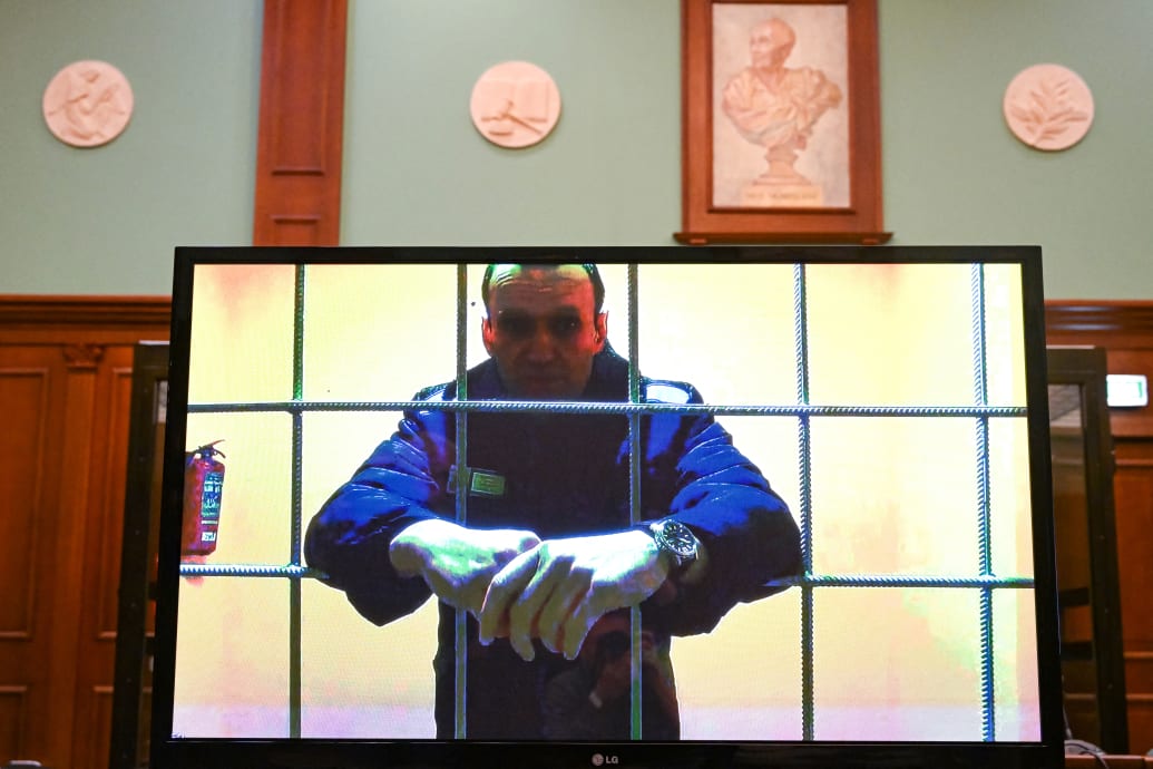Photograph of a screen showing Alexei Navalny imprisoned