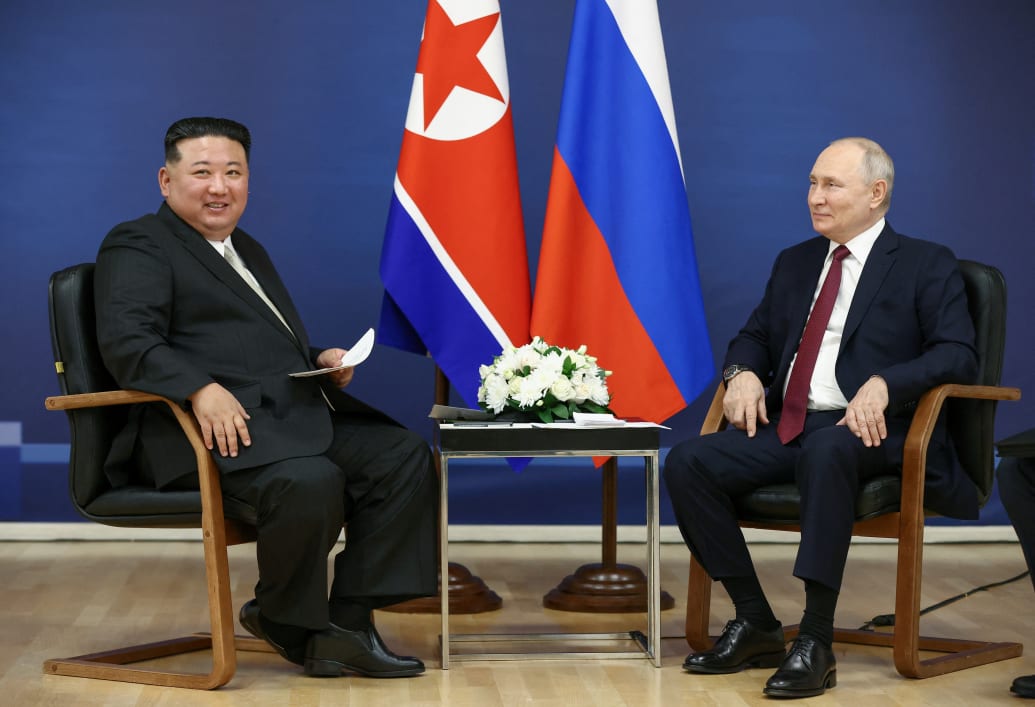 Vladimir Putin and Kim Jong Un smile for the cameras at their meeting in the far eastern Amur region.