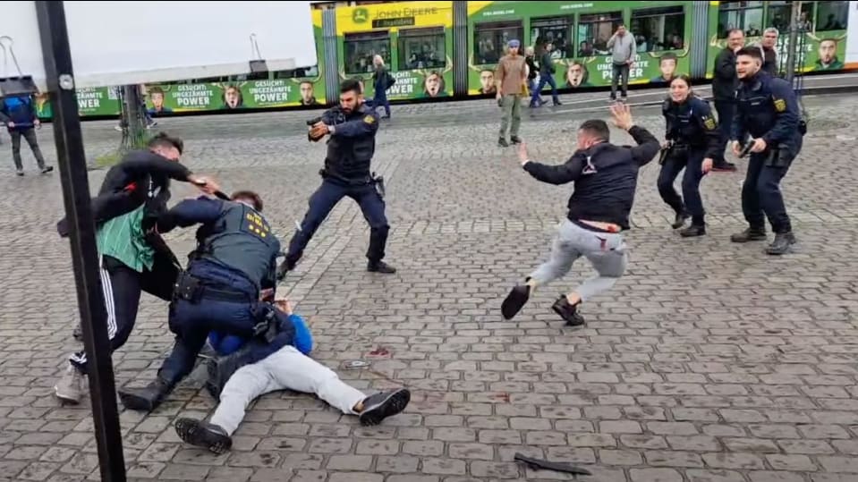 Still image from YouTube footage showing knife attacker and armed police