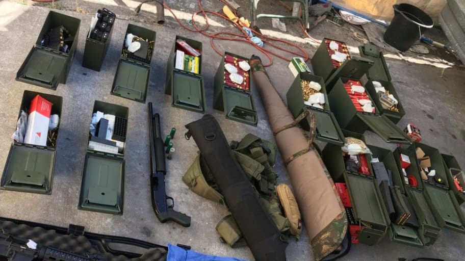 Illegal high-capacity magazines and an assault rifle along with multiple guns, ammunition are seen in this Long Beach Police Department