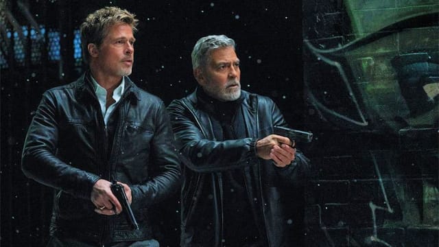 A photo still of Brad Pitt and George Clooney in Wolfs