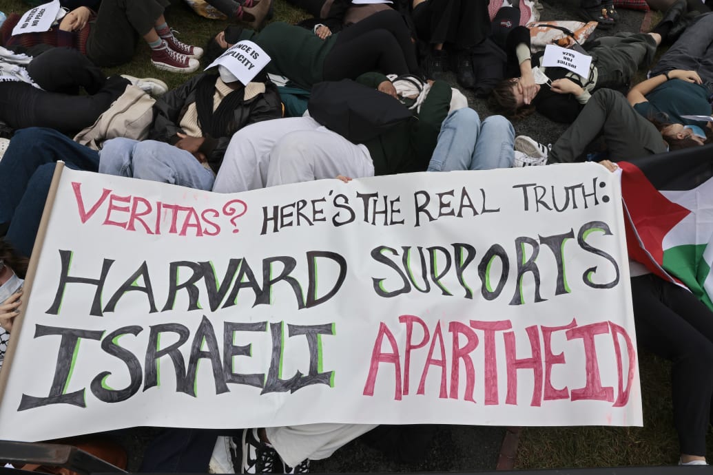 A photo including a pro-Palestinian protest of Harvard students n the lawn behind Klarman Hall, at Harvard Business School