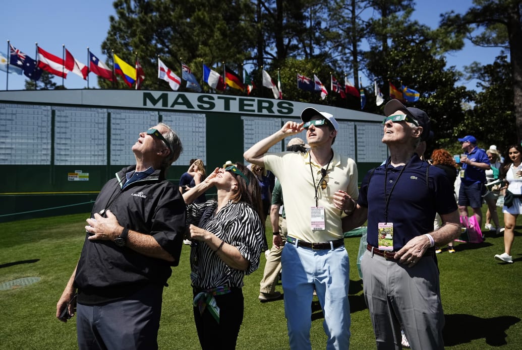 Spectators at the Masters in Augusta, Georgia, view the eclipse.