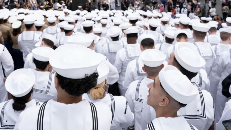 A group of U.S. Navy Sailors gather on the iconic red steps in Times Square for a group photo with U.S. Marines, U.S. Coast Guardsmen, Royal Navy Sailors and Royal Canadian Navy Sailors during Fleet Week New York (FWNY), May 24, 2023.