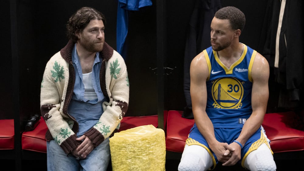 A photo still of Adam Pally and Stephen Curry