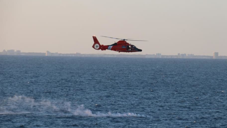 A Coast Guard helo is overflying the debris site