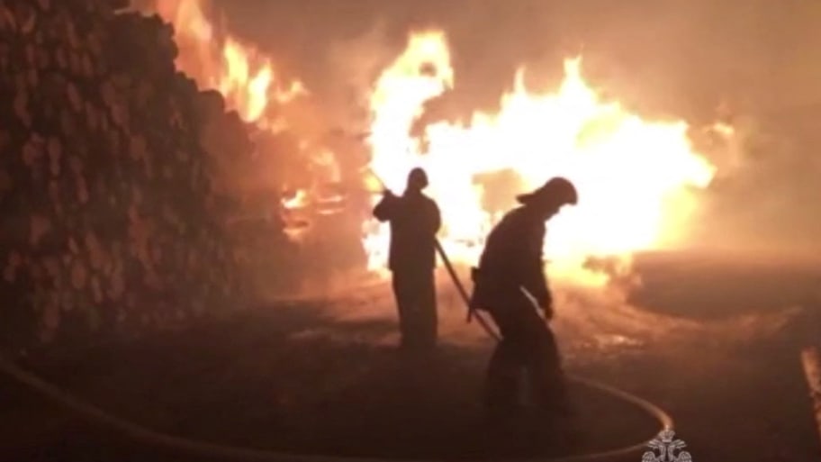 Firefighters work to put out a fire raging in the settlement of Sosva in the Sverdlovsk Region, Russia, in this still image taken from video released April 26, 2023. 