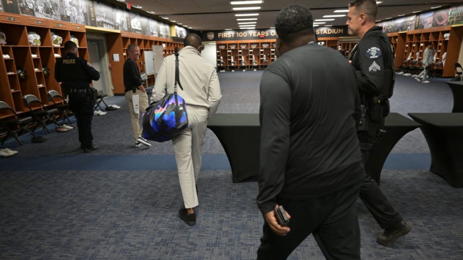 Deion Sanders walks through the locker room after arriving at Rose Bowl Stadium