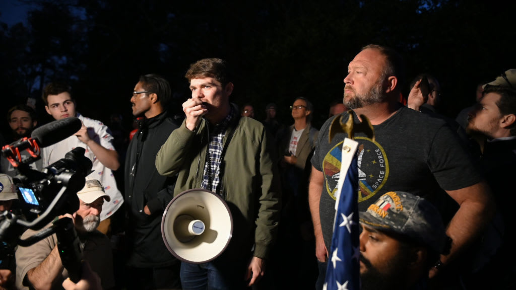 Nick Fuentes joins conspiracy theorist Alex Jones and Ali Alexander during a 'Stop the Steal' rally at the Governor's Mansion in Georgia shortly after the 2020 election.