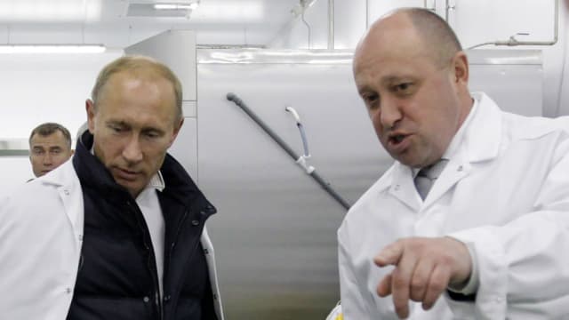 Yevgeny Prigozhin shows Russian Prime Minister Vladimir Putin on a tour of a factory in 2010.