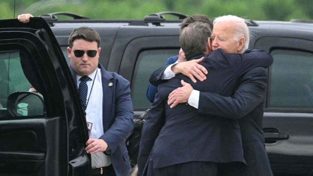 U.S. President Joe Biden hugs his son Hunter Biden upon arrival at Delaware Air National Guard Base in New Castle, Delaware.