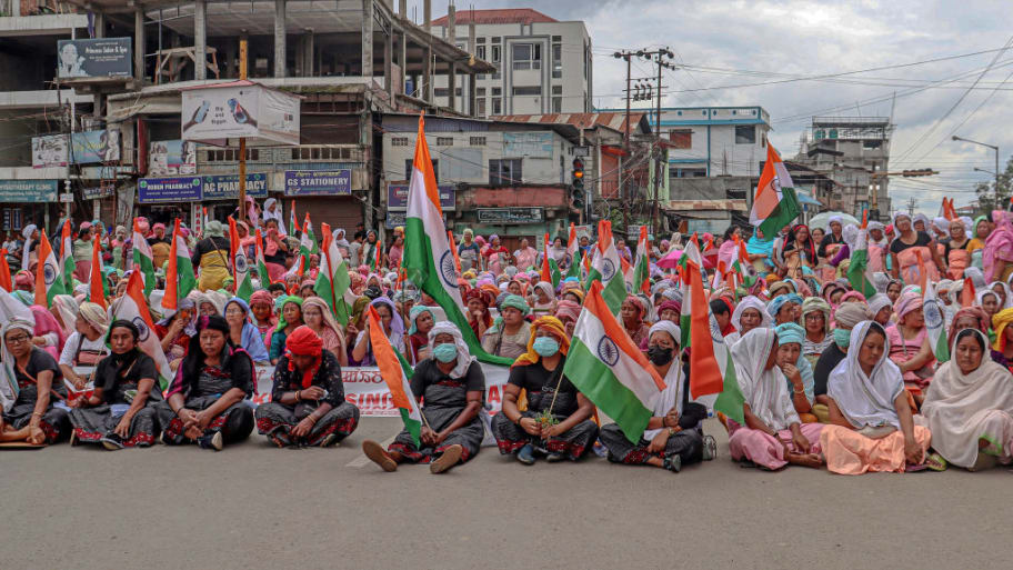 Women holding national flags take part in a demonstration demanding for the restoration of peace in India's north-eastern Manipur state in Imphal on July 17, 2023.