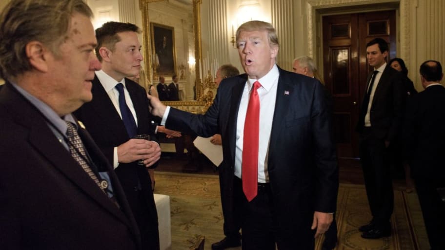 Former U.S. President Donald Trump greets Elon Musk.