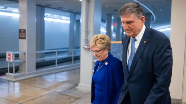 Joe Manchin (D-WV) walks with his wife Gayle Conelly Manchin in the in the Senate subway at the U.S. Capitol on February 4, 2020 in Washington, DC.