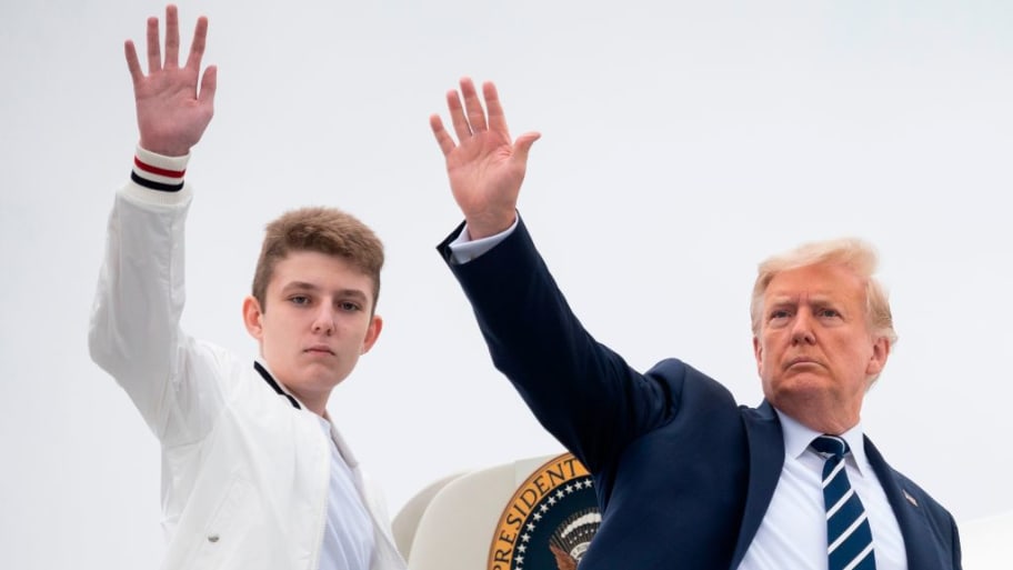 U.S. President Donald Trump and his son Barron wave as they board Air Force One.