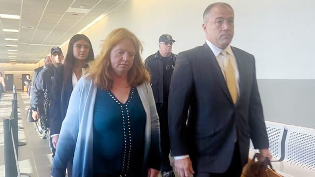 Asa Ellerup walks with her lawyers into a New York courtroom.