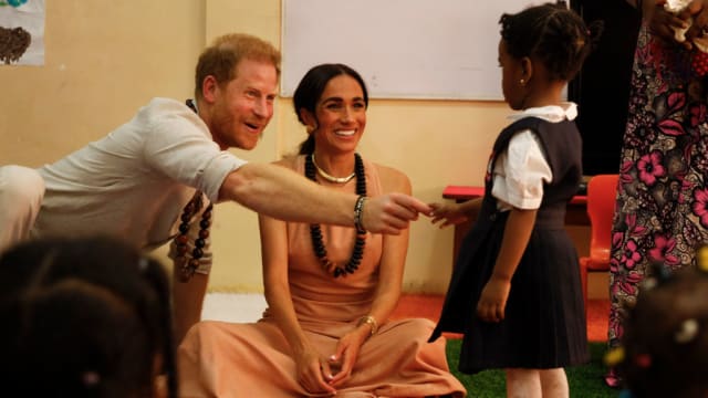Prince Harry and Meghan Markle visit the Lightway Academy in Abuja, Nigeria.