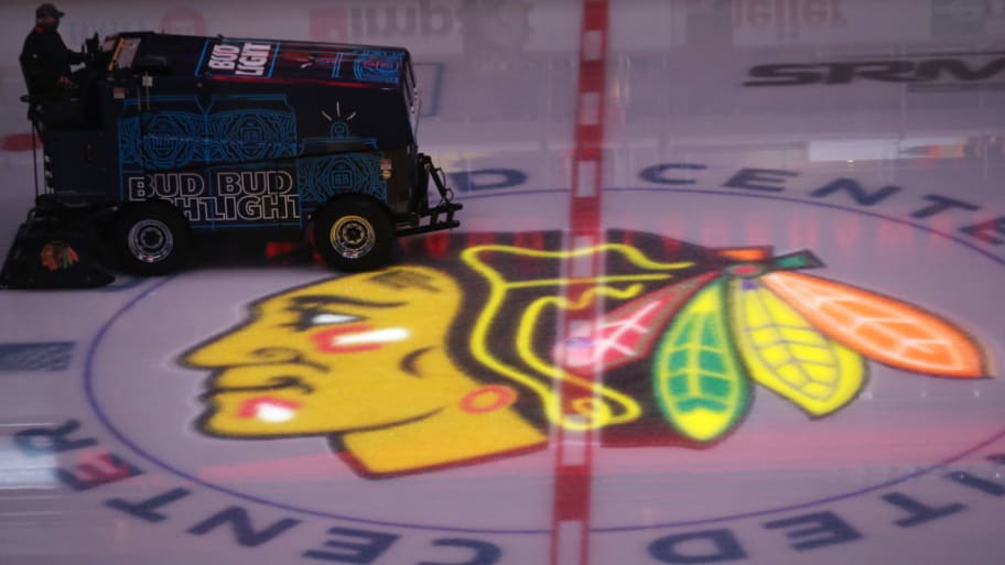 The ice is smoothed as the Chicago Blackhawks logo is illuminated before a game against the Nashville Predators at United Center on April 23, 2021, in Chicago. 