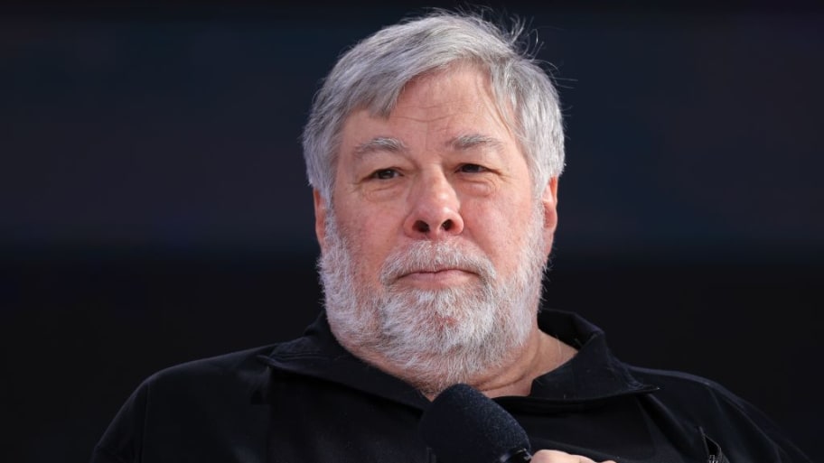 Steve Wozniak holds a microphone as he speaks on stage.