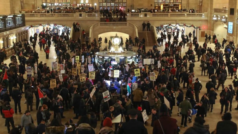 Protesters hold posters and banners during a protest at Grand Central Terminal in New York.