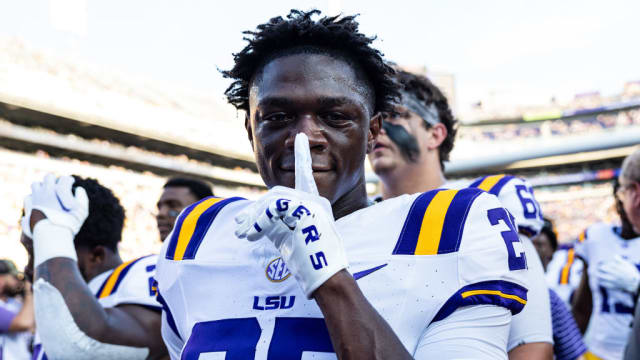 Trey Holly holds up a finger to his mouth on the sidelines of an LSU football game.