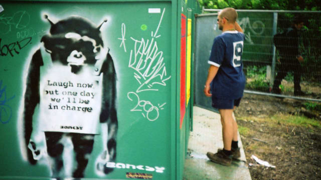 A stencil artwork of an ape by Banksy is pictured on a toilet block at the Glastonbury festival at Worthy Farm on June 25, 2000 in Pilton, United Kingdom. 
