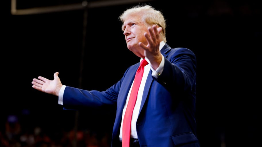 Former U.S. President Donald Trump walks toward the stage to speak at a rally at Montana State University.