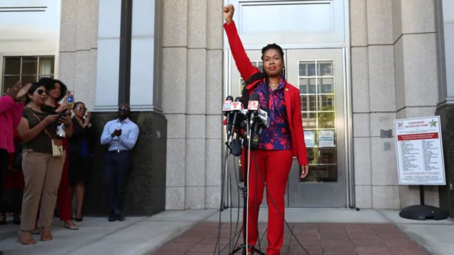 Orange-Osceola State Attorney Monique Worrell ends her press conference with a raised fist outside her former office in the Orange County Courthouse complex, Aug. 9, 2023.